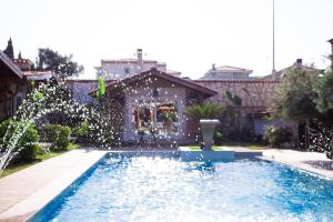 a swimming pool in the yard of a house at Etiz Hotels Alaçatı in Çeşme