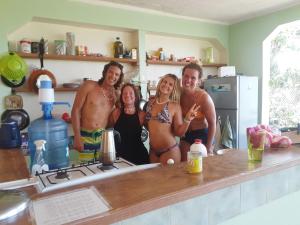 a group of people standing in a kitchen at La Hacienda Hostel in Las Galeras