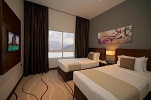 Postel nebo postele na pokoji v ubytování Action Hotel Ras Al Khaimah