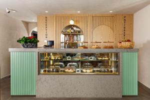 a display case in a kitchen with pots and pans at Sherwood Premio Hotel in Antalya