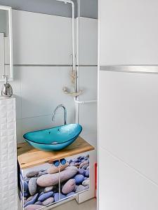 a bathroom with a blue sink and towels at Haus Nathalie in Trzęsacz