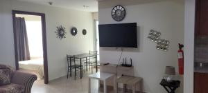 a living room with a flat screen tv on a wall at Cozy 2BHK Near to DMCC Metro Station -505 in Dubai