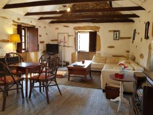 a living room with a couch and a table at A Cancela House Arouca Paiva Walkways in Lázaro