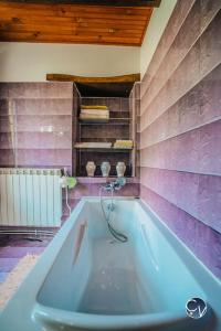 a bath tub in a bathroom with purple walls at ☆MAISON PROVENCALE☆3chambres☆Idéal famille in Saint-Marcel-de-Carreiret
