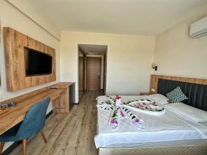 a hotel room with a bed and a tv at Kaya Garden Side in Side +20 photos