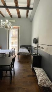 a room with two beds and a table and chairs at Anima Partenopea in Naples