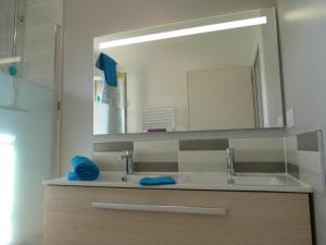 a bathroom with a sink and a large mirror at Domaine des Hameaux du Lac - BG in Saint-Pardoux +17 photos
