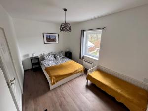 a bedroom with a bed and a window at Almás Tanya Vendégház in Szuha