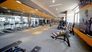 a gym with rows of treadmills and machines at Happiest Homestay 2 - Manor Crown Hue in Thôn Trường Giang