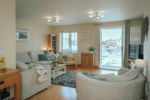 a living room with two couches and a tv at Harbour Views at Silver Strand in Pevensey