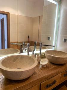 a bathroom with three sinks and a large mirror at 2 bedroom "Pine Hug" apartment in Borovets