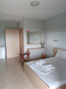 a bedroom with a bed with two towels on it at Athos Bay Villa in Ammouliani +27 photos