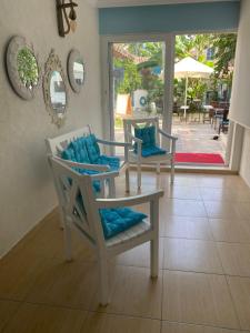 a room with two chairs and a table and a patio at Mavi Butik Apart in Çeşme