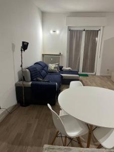 a living room with a couch and a table and chairs at Smart Holiday in Capriate San Gervasio
