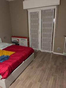 a bedroom with a bed with a red blanket at Smart Holiday in Capriate San Gervasio