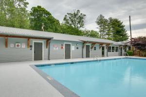 a large swimming pool in front of a building at Chic Flat Rock Tiny Home with Community Pool Access! in Flat Rock