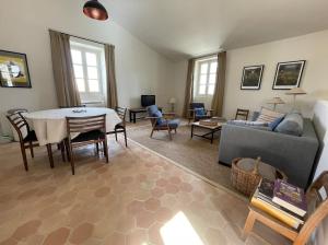 a living room with a table and a couch at VENTOUX in Apt
