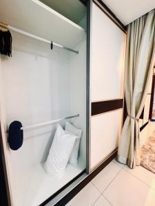 a glass closet with a pillow in it at Mont kiara 5-Star Deluxe Suite 2-4pax in Kuala Lumpur