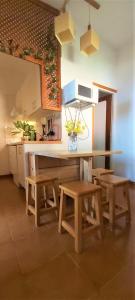 a kitchen with a table and two benches and a counter at Casa Pepito in Agulo