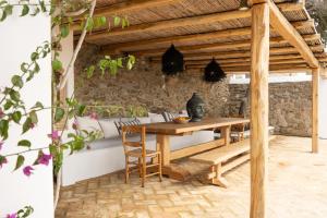 a wooden table and chairs on a patio at Villa Baroness in Mykonos Town in Mýkonos City