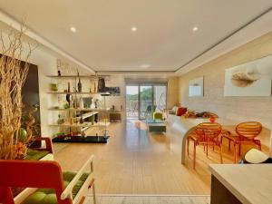 a living room with a couch and a table and chairs at Sea view Apartments Panorama Przno in Sveti Stefan