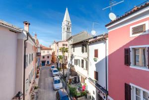 a city street with a church steeple in the distance at Apartment Mare in Vrsar