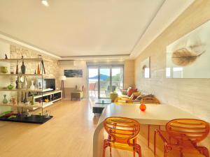 a kitchen and living room with a table and chairs at Sea view Apartments Panorama Przno in Sveti Stefan