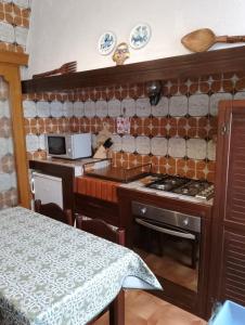 a small kitchen with a stove and a counter top at a un passo dal mare in Lido di Ostia