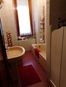 a bathroom with a sink and a toilet and a tub at a un passo dal mare in Lido di Ostia
