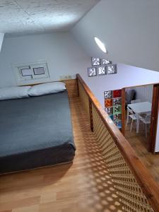 a room with a bed and a staircase with a table at Apartamento monte dorado in Málaga