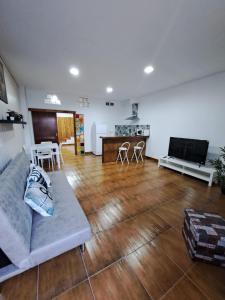 a large living room with a couch and a kitchen at Apartamento monte dorado in Málaga