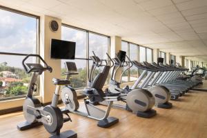 a gym with a row of cardio bikes and treadmills at Four Points By Sheraton Nairobi Hurlingham in Nairobi