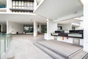 an empty lobby of a building with a staircase at Sierra Grand Broadbeach - Self Contained & Privately Managed - Wow Stay in Gold Coast