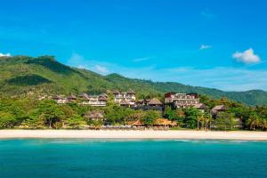 a group of houses on a beach near the water at Vana Belle, A Luxury Collection Resort, Koh Samui in Chaweng Noi Beach