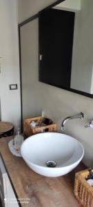 a white sink in a bathroom with a mirror at Centro Storico in Chiari