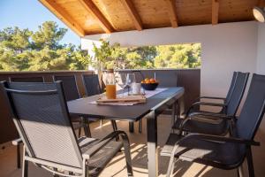 a blue table and chairs on a patio at Apartmani Lavanda in Bibinje