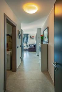 a hallway leading to a living room with a couch at Rijeka Relax Apartment with parking in Rijeka
