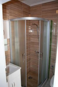a shower with a glass door in a bathroom at Villa Scandik Ohrid in Ohrid