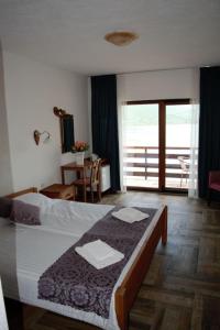 a bedroom with a bed with two towels on it at Villa Scandik Ohrid in Ohrid