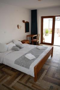 a bedroom with a large bed and a large window at Villa Scandik Ohrid in Ohrid