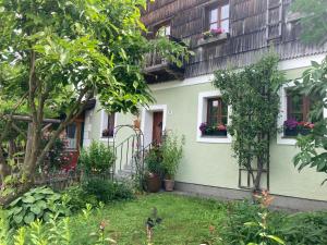 a green house with flower boxes on the windows at Schreiner in Wernstein am Inn