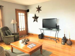 a living room with a television and stars on the wall at Home near Zoo/College World Series/Downtown in Omaha