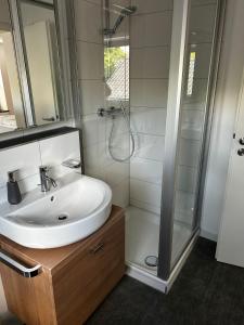 a bathroom with a sink and a shower at Alte Schmiede - XXL Foodhouse in Kempten