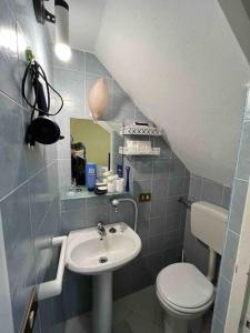 a small bathroom with a sink and a toilet at Tenuta Balabaia, Townhouse. in Caccamo