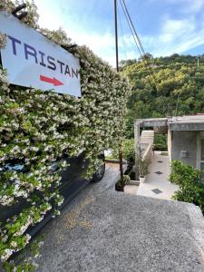 a sign on a building with flowers on it at Apartman Tristan in Herceg-Novi