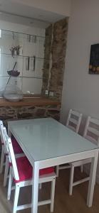 Biały stół i krzesła w pokoju w obiekcie TraviesaBetanzos w mieście Betanzos