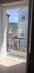 a view from an open window of a balcony at TraviesaBetanzos in Betanzos