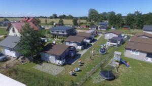 an aerial view of a small house with a playground at Domki u Basi in Gąski