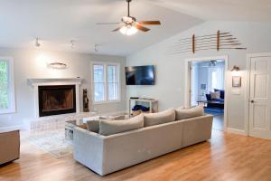 a living room with a couch and a fireplace at Ravenswood Pool House in Sawyer