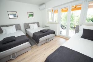 a bedroom with two beds and a balcony at Villa Kosor Spring in Blagaj +50 photos